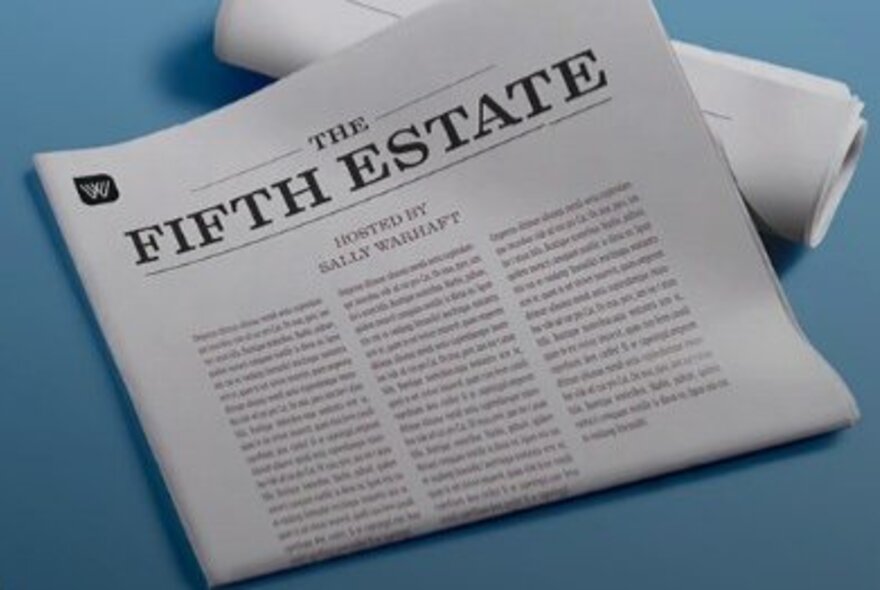 A printed newlsetter titled, The Fifth Estate, folded and resting on a blue surface.