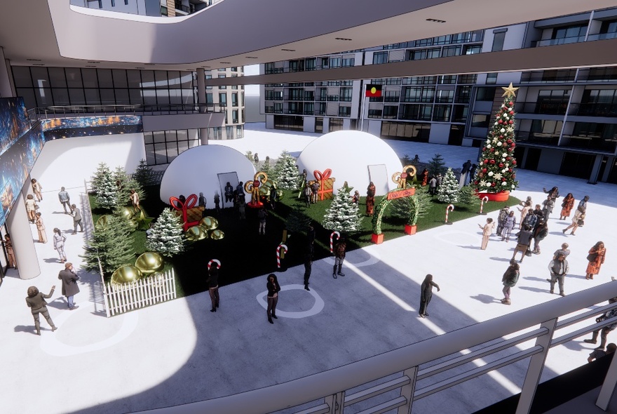 The Christmas themed square at Marvel Stadium with large Christmas trees, a garden area, and people walking around.