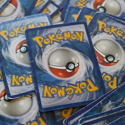 A messy, spread out pile of Pokémon cards.