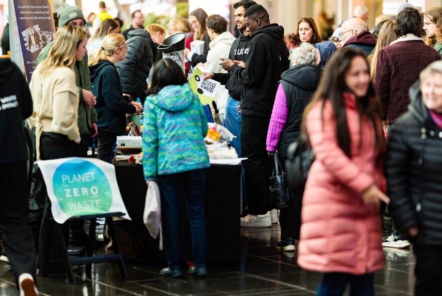 People looking at stalls in a busy market venue.
