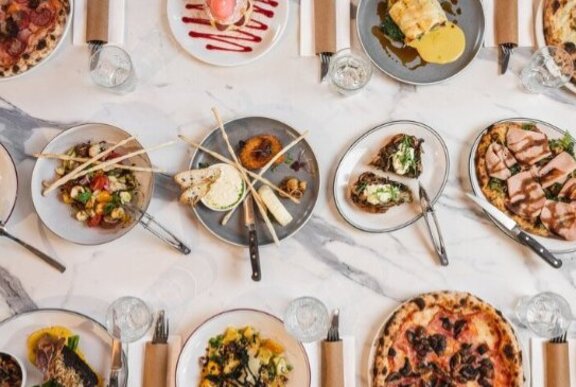 Three rows of neatly lined up dishes of Italian food.