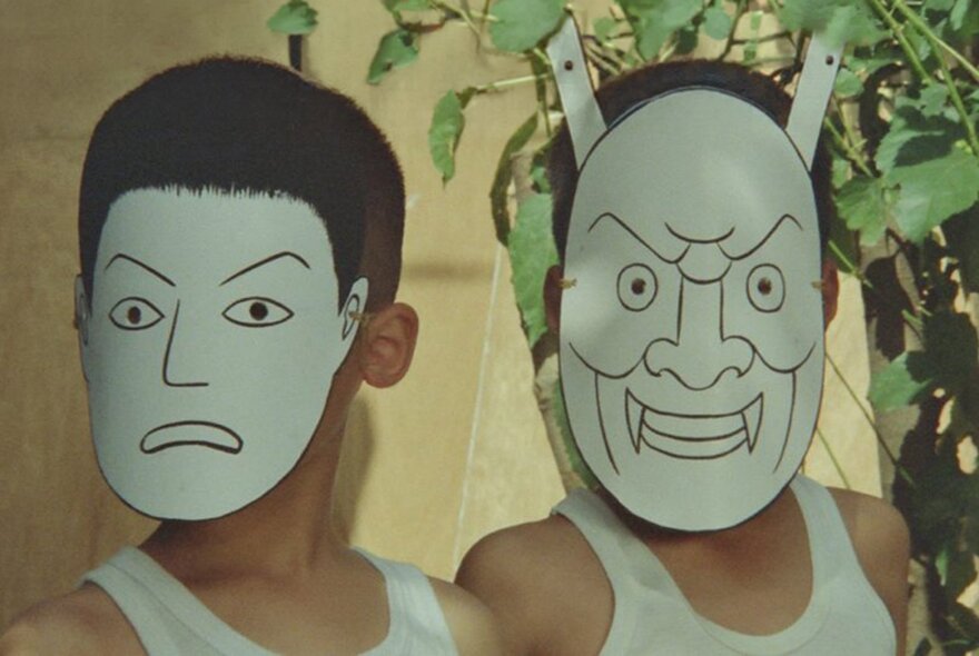 Two people in white singlets with hand drawn face masks on. 