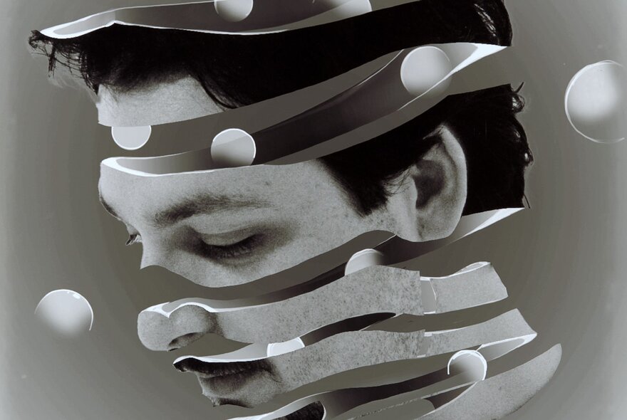 A fragmented and layered black and white image of a person's face.