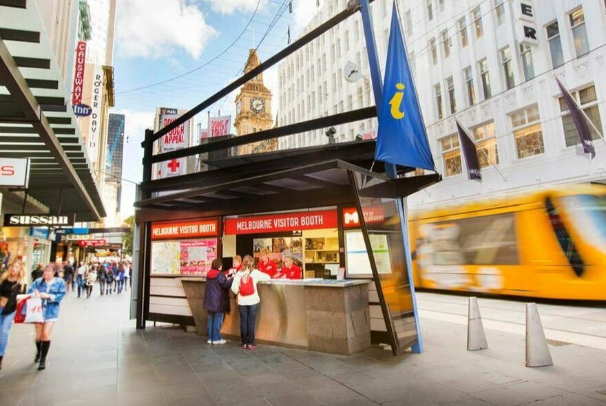 The information stand in Melbourne, with a blurred tram in the background.