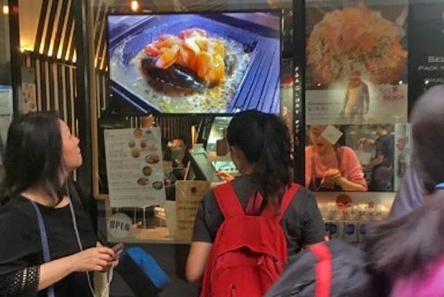 Customers ordering Japanese takeaway food.