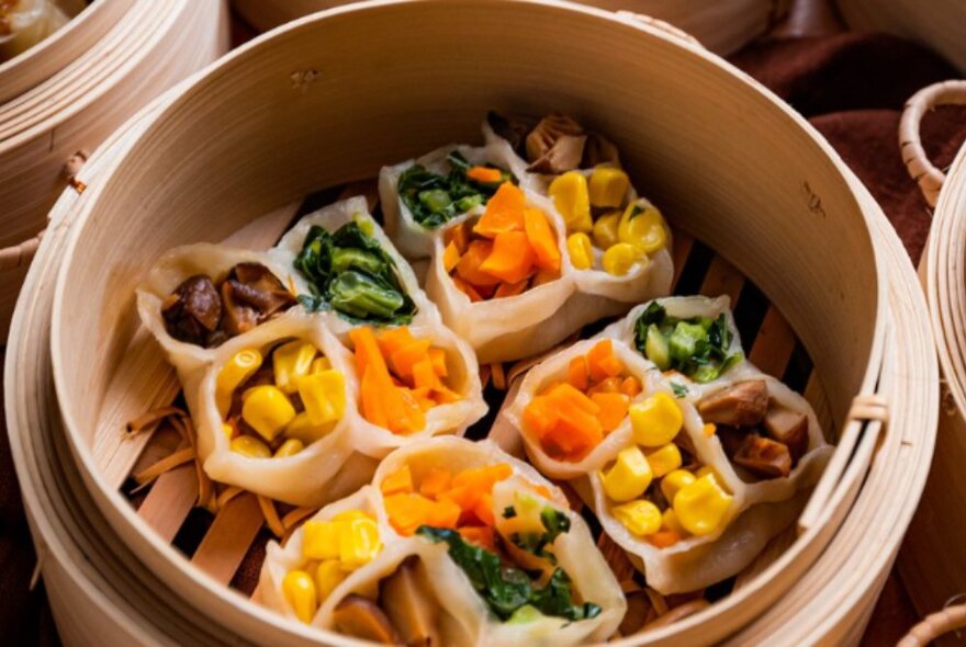 Bamboo steamer with meat and vegie dim sum pockets.