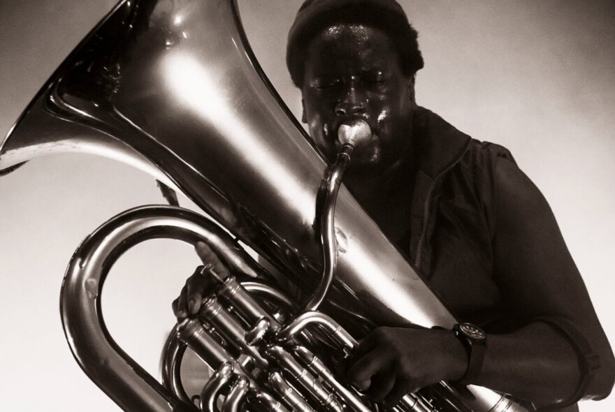 Musician playing a large tuba.
