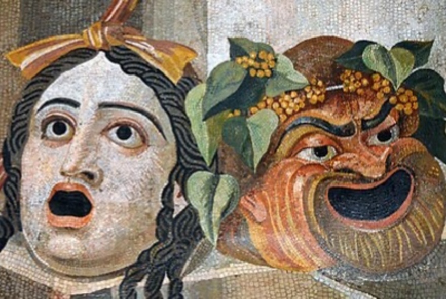 Ancient Roman wall mosaic of two theatrical masks depicting the faces of comedy and tragedy.