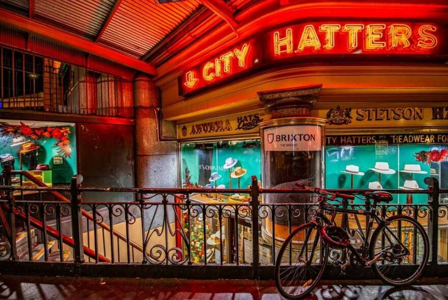 Shopfront of hat store with red neon sign