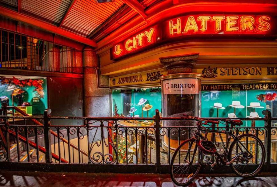 Shopfront of hat store with red neon sign