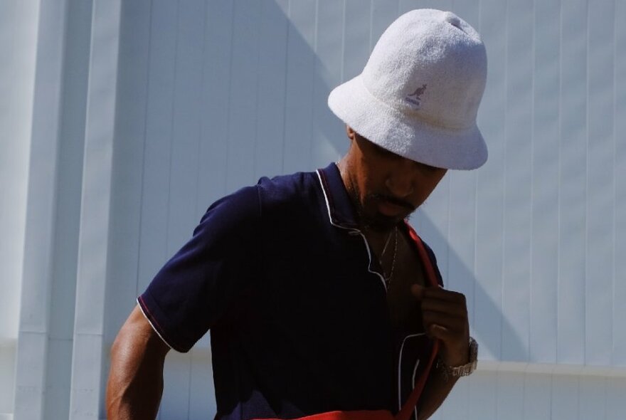 A man wearing a white bucket hat