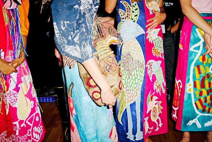 Close up of people wearing Batik style prints in bright colours. 