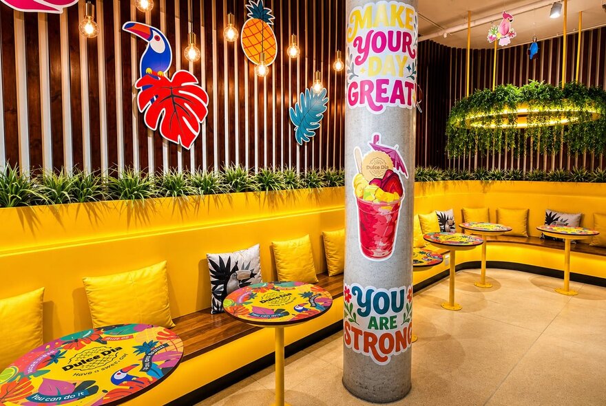 The vibrant, tropical-themed interior of Dulce Día, a Colombian dessert cafe.