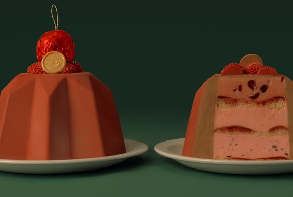 Two chocolate Christmas cakes, one a cross-section, with a red bauble on top. 