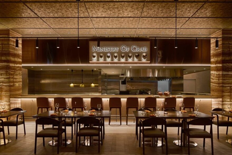 Formal dining room with tables and chairs, bench seating and bar area.