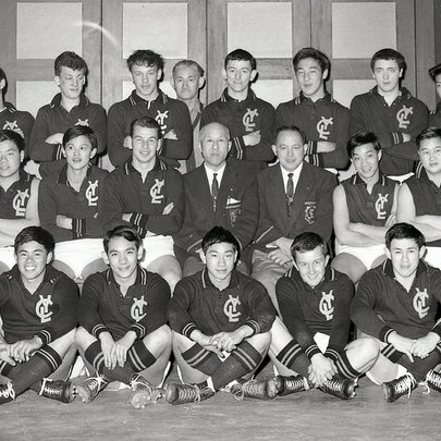 A black-and-white posed team photograph of the Young Chinese League Australian rules football team from the mid-20th century.