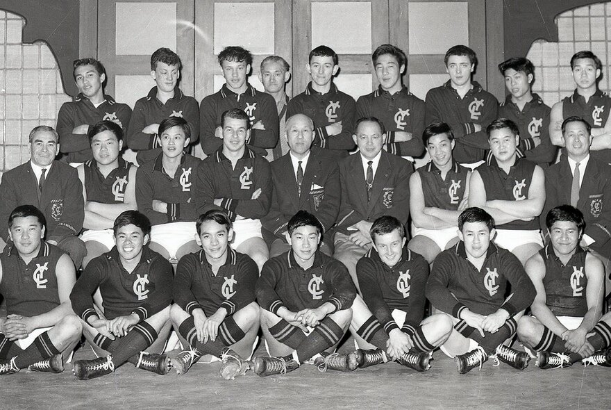 A black-and-white posed team photograph of the Young Chinese League Australian rules football team from the mid-20th century.