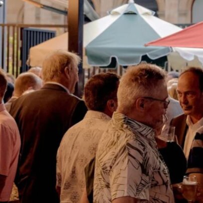 A crowd enjoying a drink at a terrace bar.