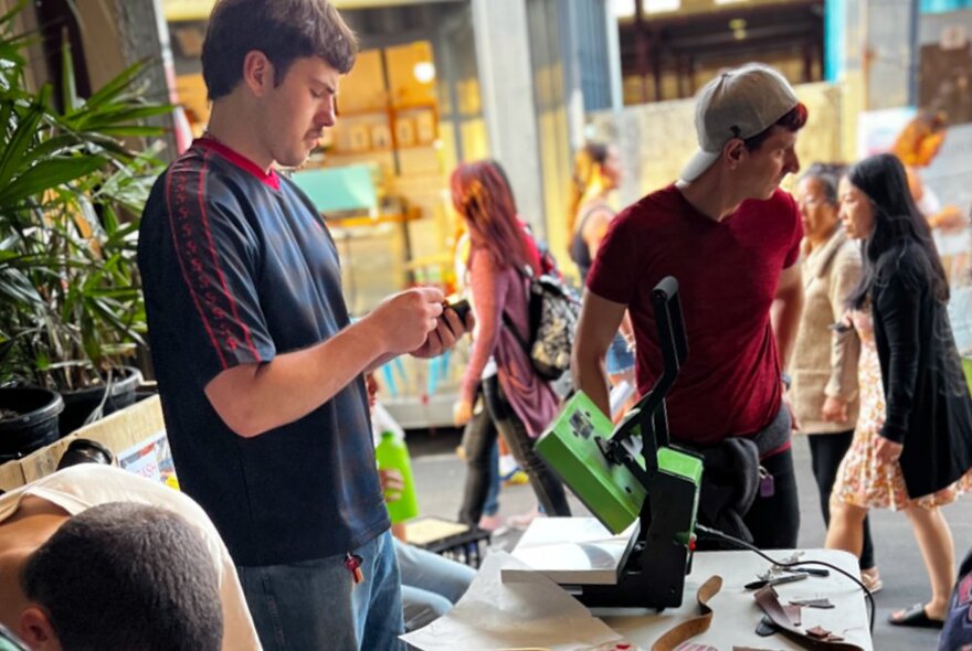 People making things out of recycled soft plastics in an open air studio space