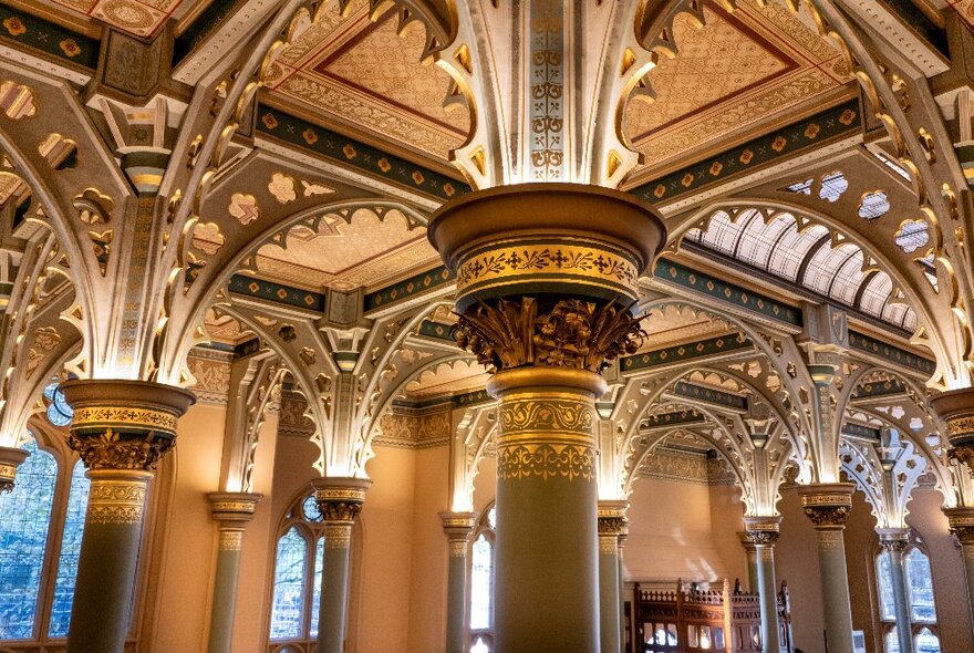 The ornate interior architecture of the Gothic Bank, showing ceiling and columns and arched windows.