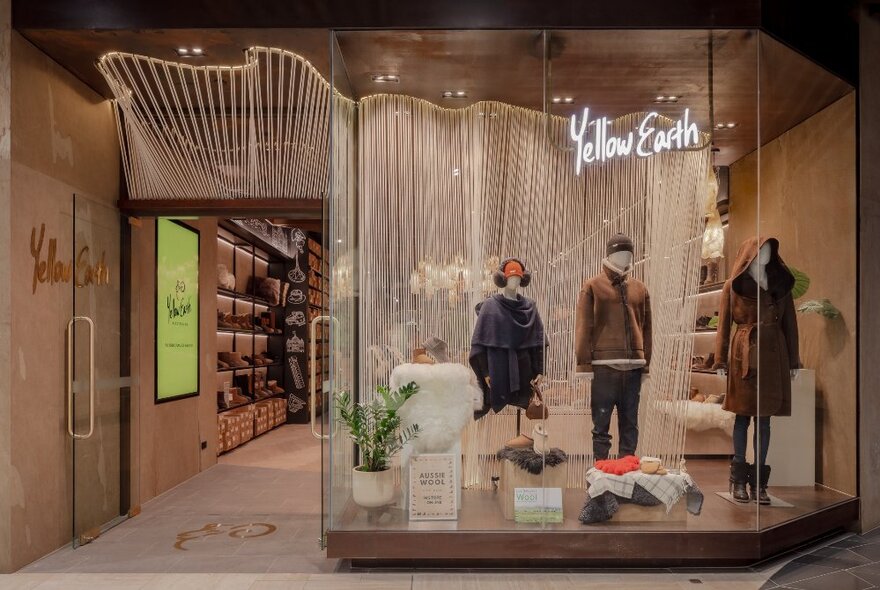 The shopfront of Yellow Earth at the Melbourne Emporium, with mannequins and a white curtain in the front window.