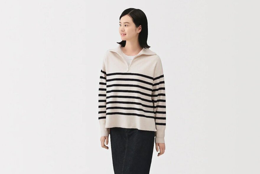 A woman wearing a striped sweater.