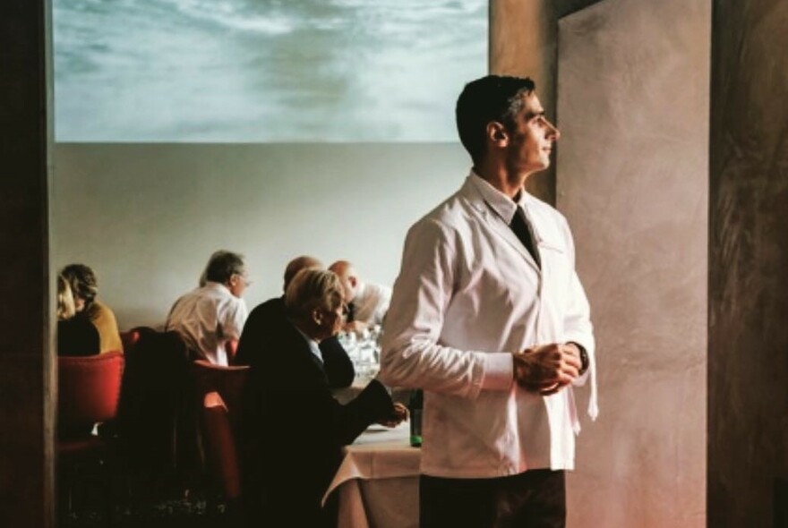 Waiter in a white jacket.