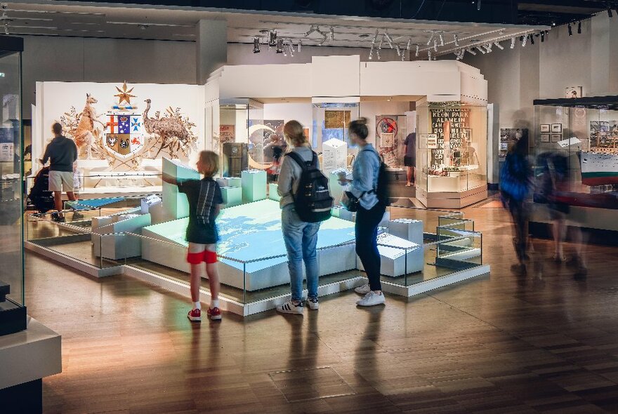 People looking at a lit up display in a glass cabinet at the Melbourne Museum.