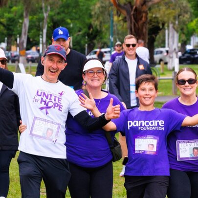 A family wearing purple Unite for Hope t-shirts as they complete a fundraising walk.