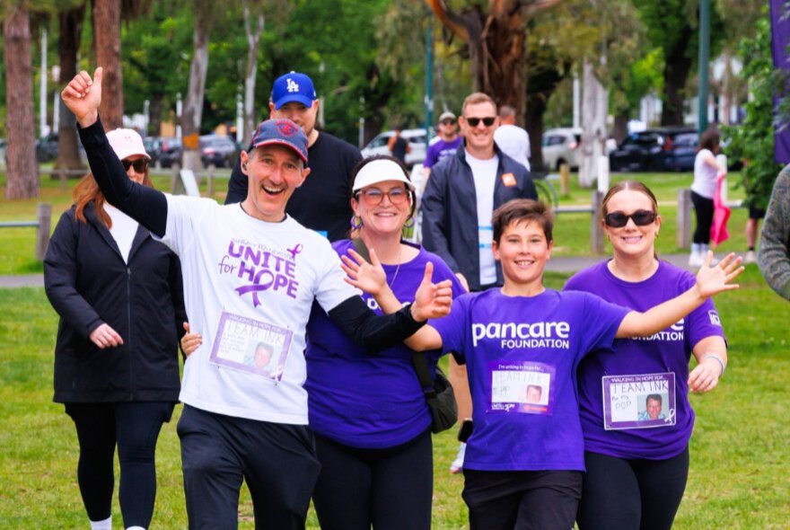 A family wearing purple Unite for Hope t-shirts as they complete a fundraising walk.