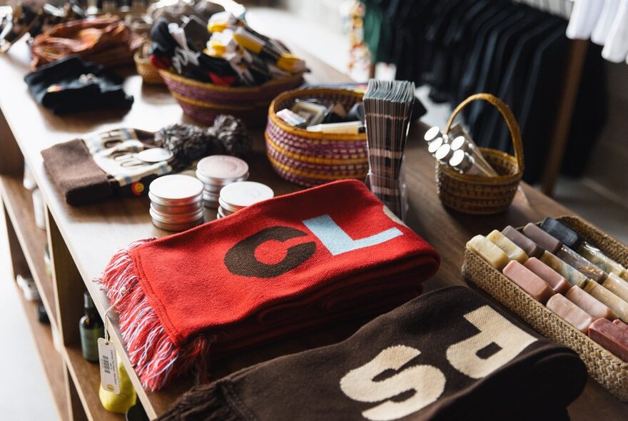 Selection of gifts and apparel displayed on a table in a a shop.