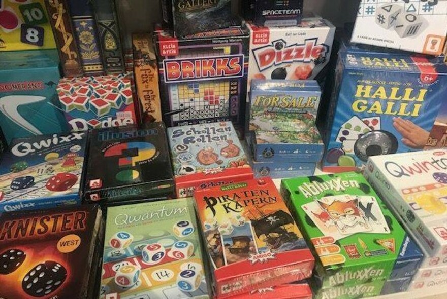 Shelf displaying rows of boxed board games.