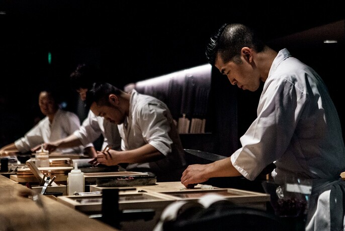 Chefs preparing Japanese food.