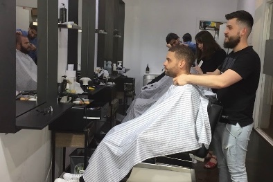 Man getting a haircut in a barber shop.