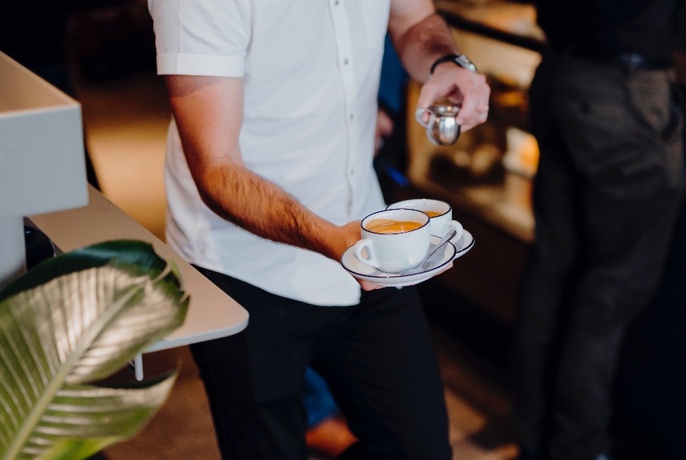 Waiter with two coffees.