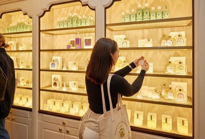 A woman browsing perfumes in a beauty store.