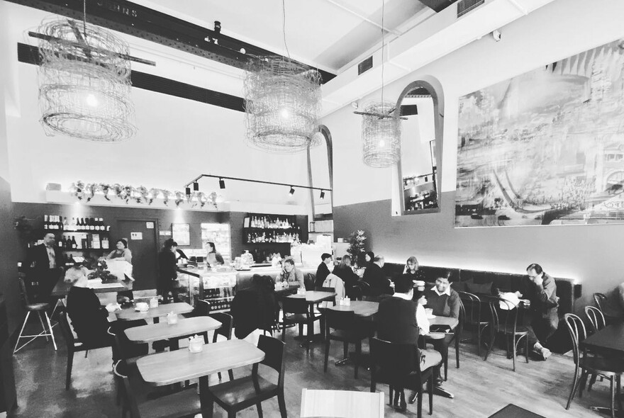 Old-style black and white image taken inside a cafe.