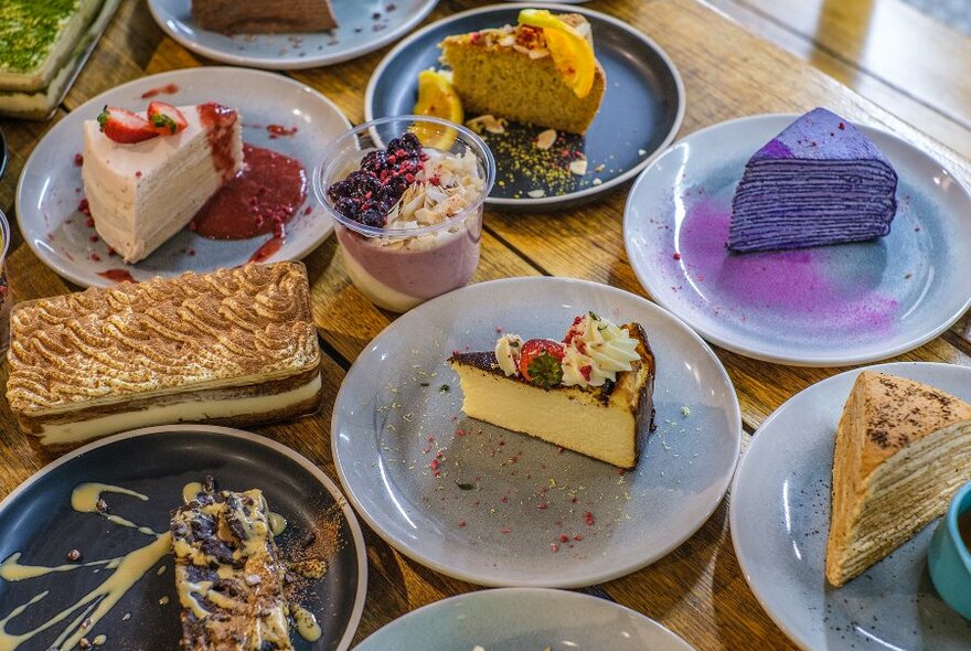 A selection of colourful cakes and desserts in a cafe.