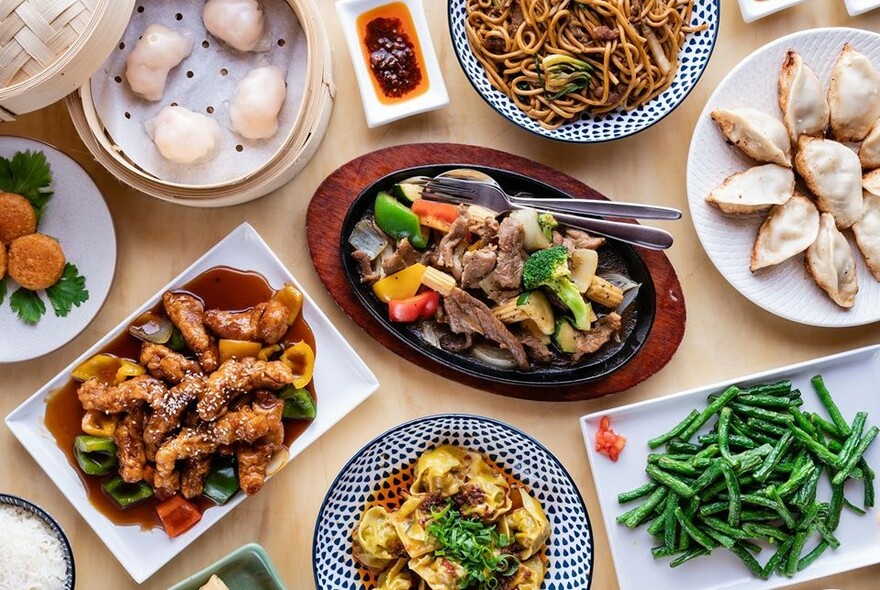 Looking down on a table full of different dishes from Shanghai Village.
