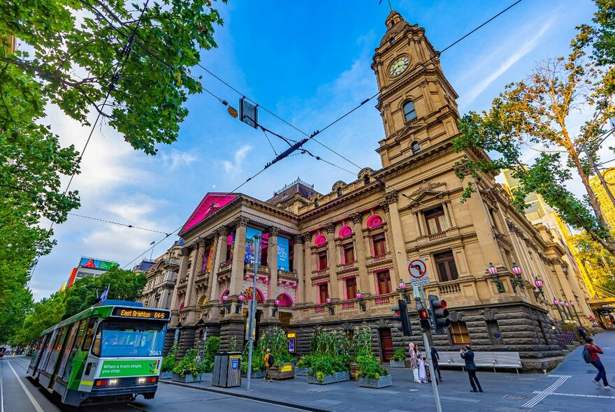 Outside Melbourne Town Hall there is a tram going past