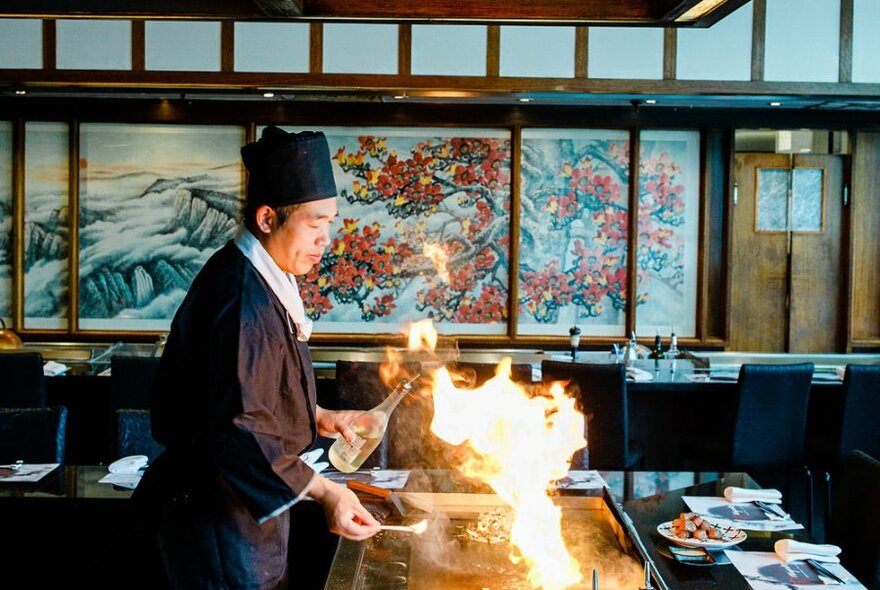 A Japanese chef tends to the teppanyaki.