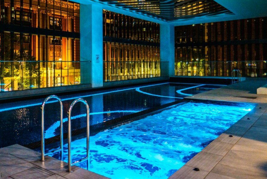 Indoor pool at the Movenpick hotel lit up at night