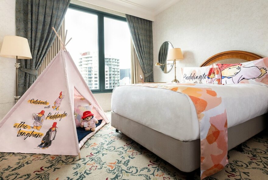 A Paddington bear themed hotel room with a pink play tent. 