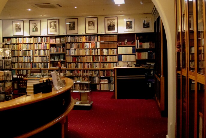 Bookshop with the walls lined with shelves of books.