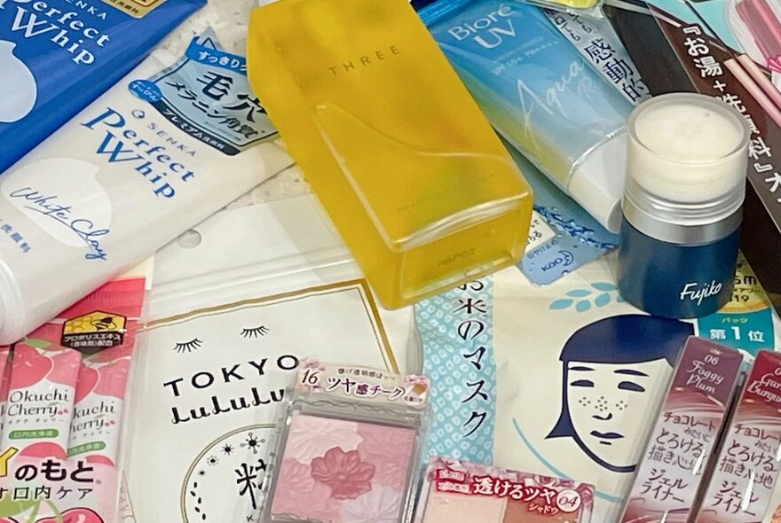 Assorted skincare and beauty products and packaging displayed on a table.