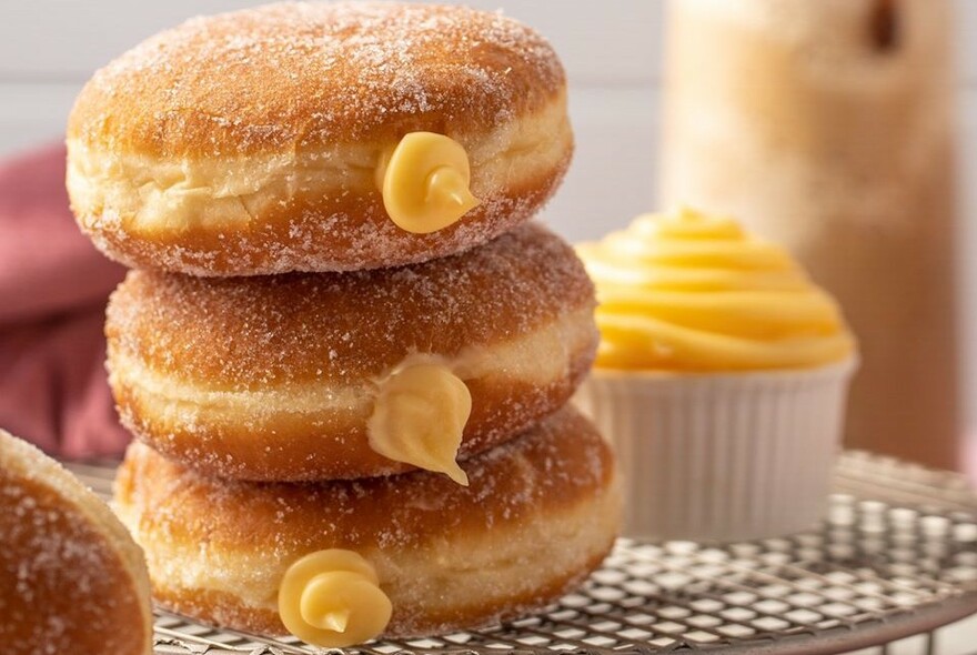 A stack of three donuts oozing custard.