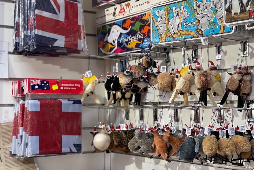 Rows of Australian animal key rings hanging on the wall next to packaged Australian tea towels.