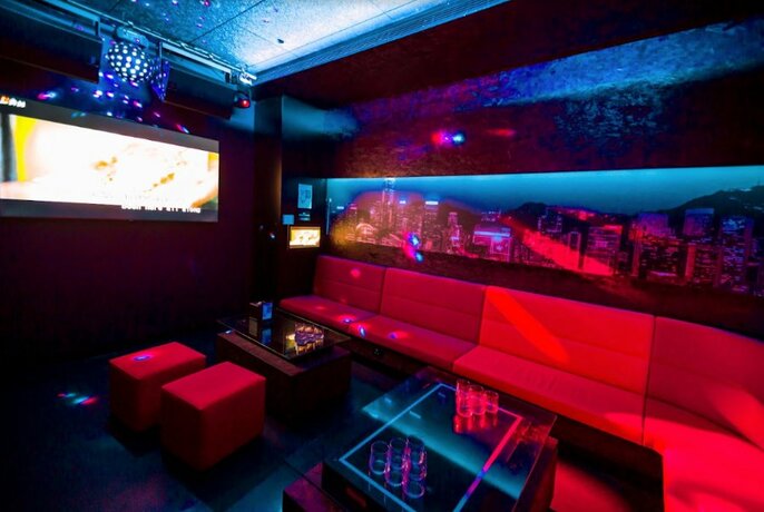 Private karaoke room with red couches.