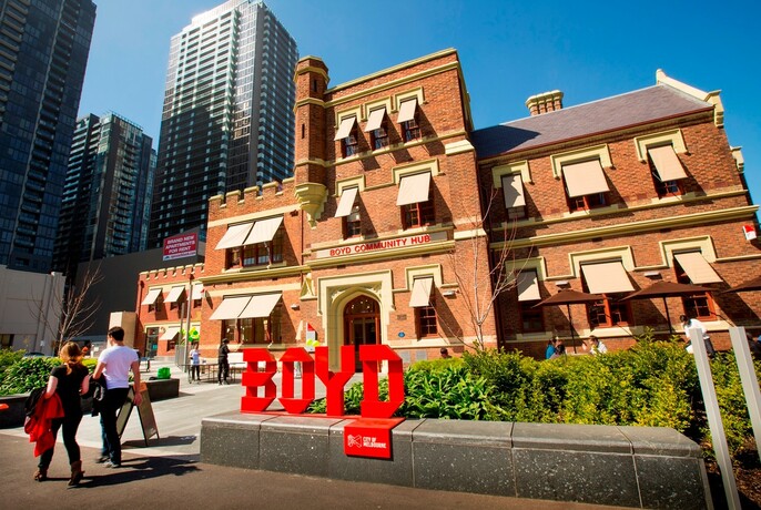 Boyd Community Hub sign outside Southbank Library, a heritage-listed old red brick building.