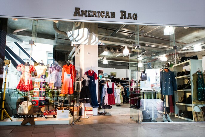 Shopfront of American Rag store with vintage fashion and accessories.